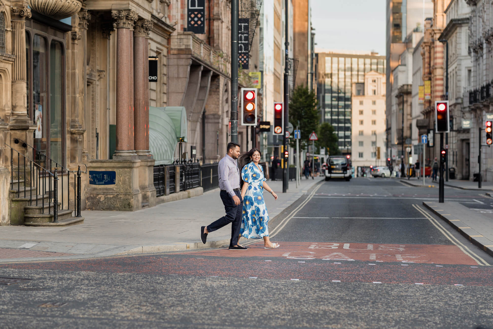 Couple crossing a quiet street in Leeds city centre during a pre-wedding photoshoot.