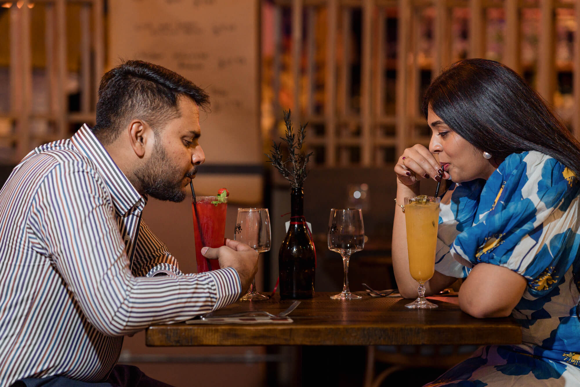 Engaged couple enjoying colourful cocktails during a romantic Leeds pre-wedding session.