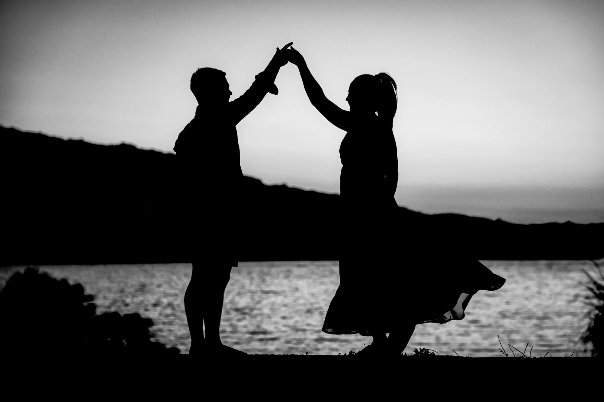 Black and white wedding photography silhouette of a couple dancing