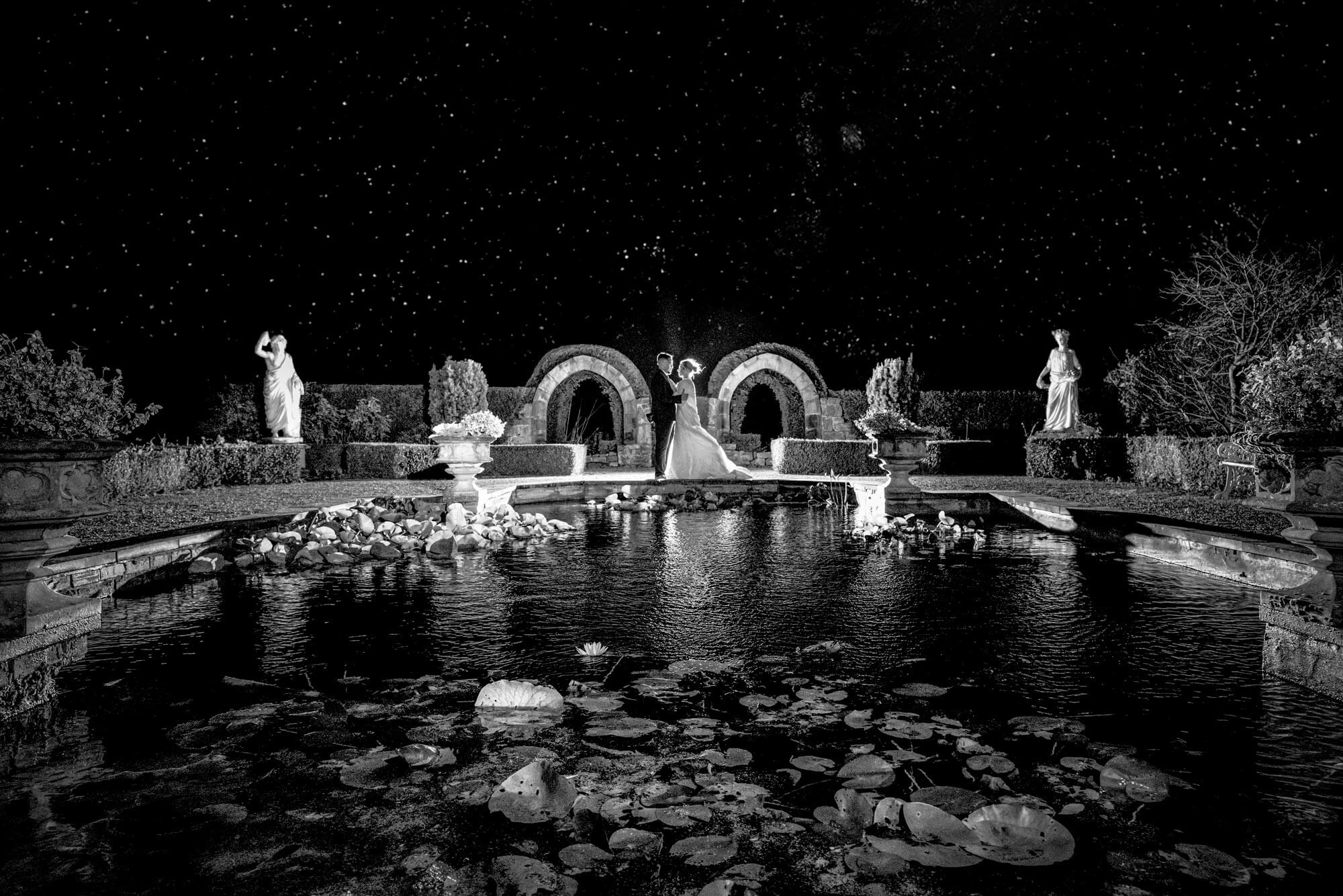 Dramatic black and white wedding portrait photographed at night