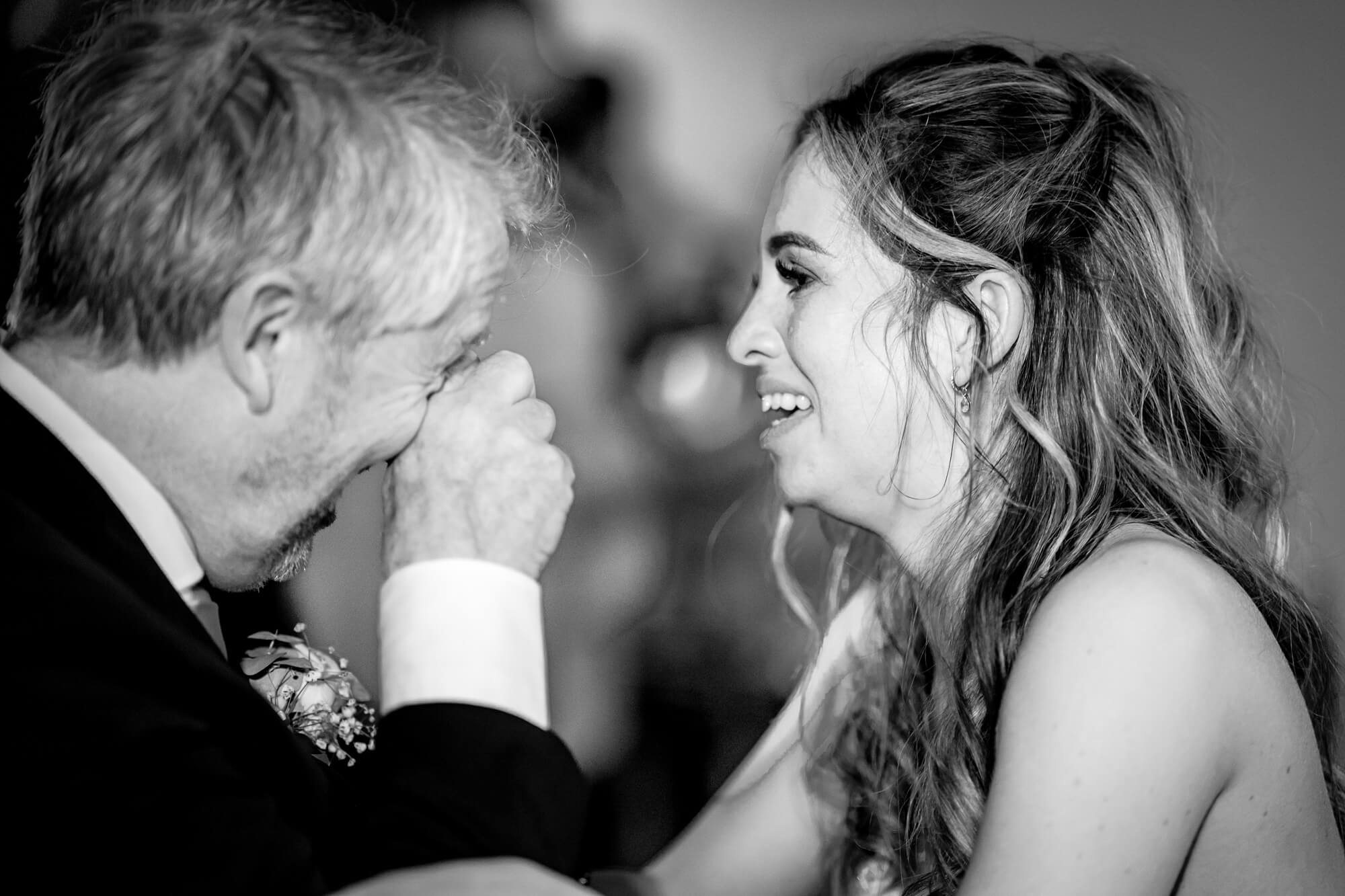 Emotional black and white wedding photograph capturing a candid moment