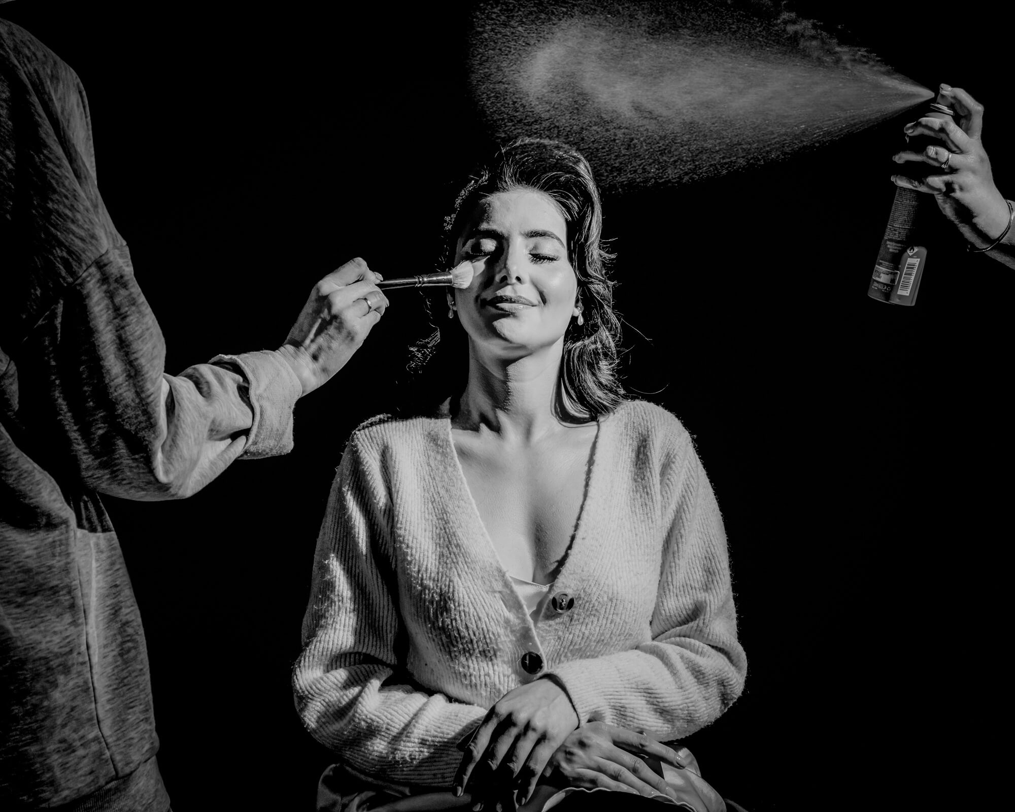 Black and white bridal preparation photograph using dramatic light