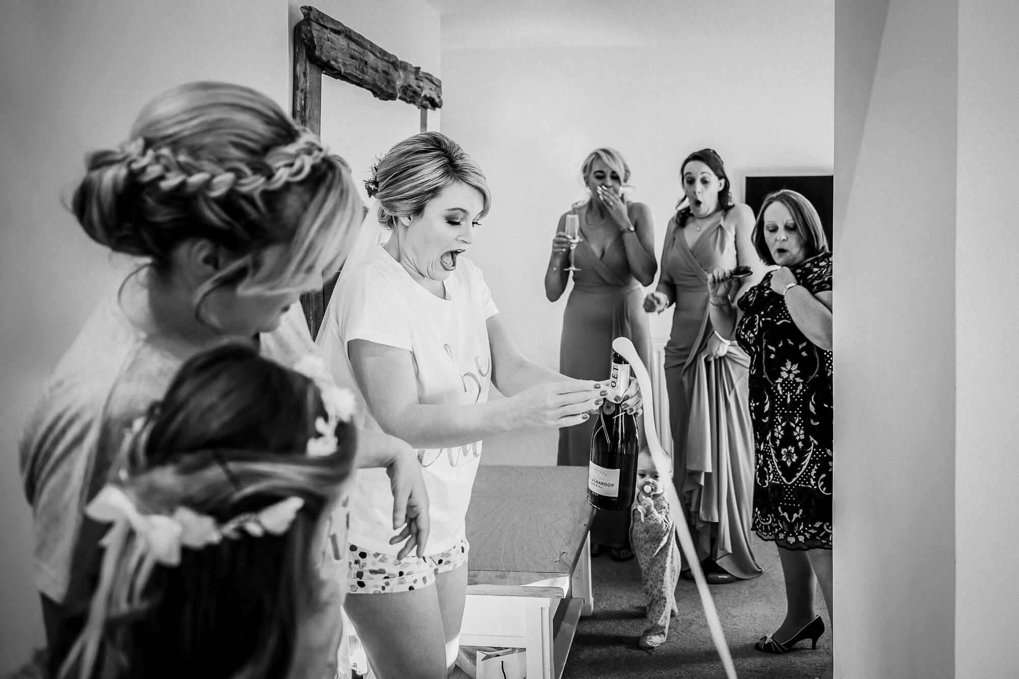 Candid black and white wedding photography during bridal preparations