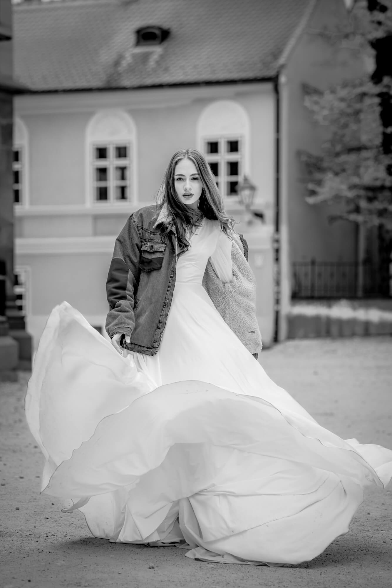 Editorial black and white bridal portrait with flowing wedding dress