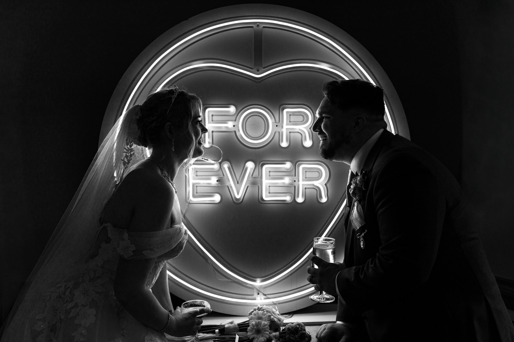 Moody black and white wedding portrait of a bride and groom