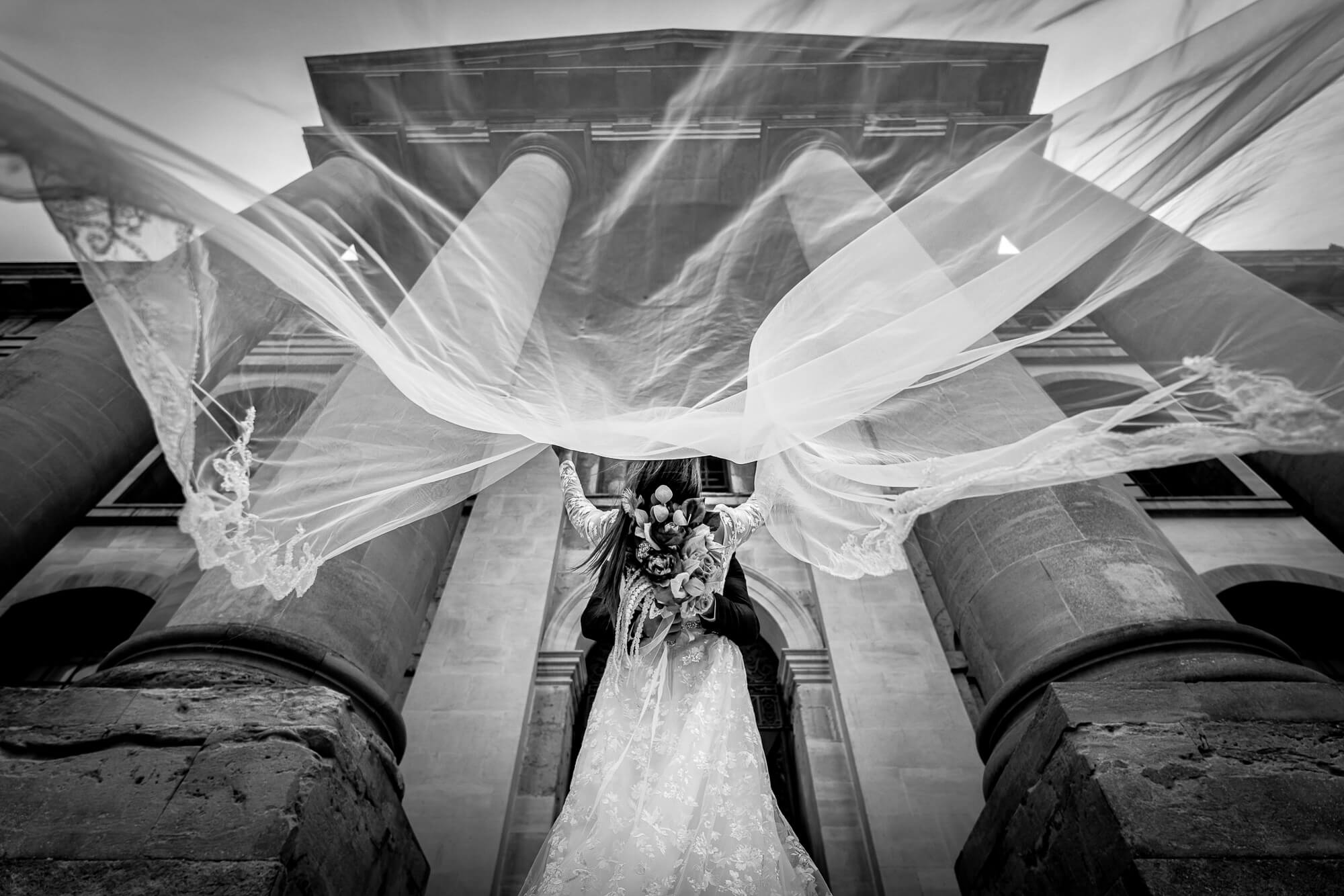 Editorial black and white wedding photography with flowing bridal veil