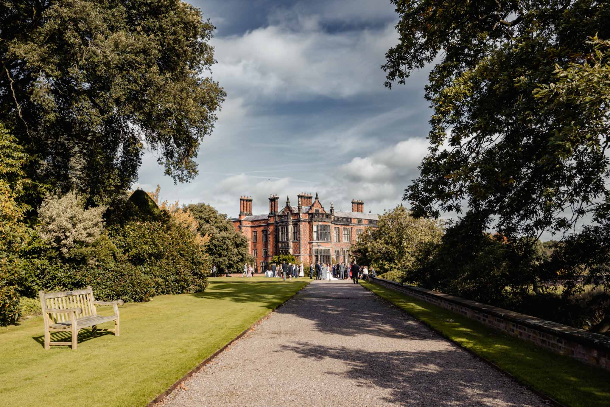 Arley Hall photographed from distance while bride and groom are having a drink.