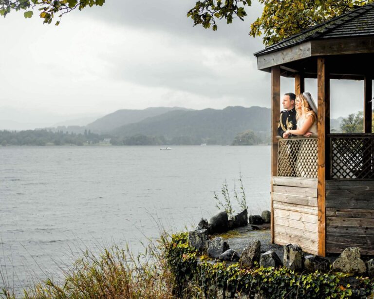 Groom and bride on the jetty, looking towards the lake.