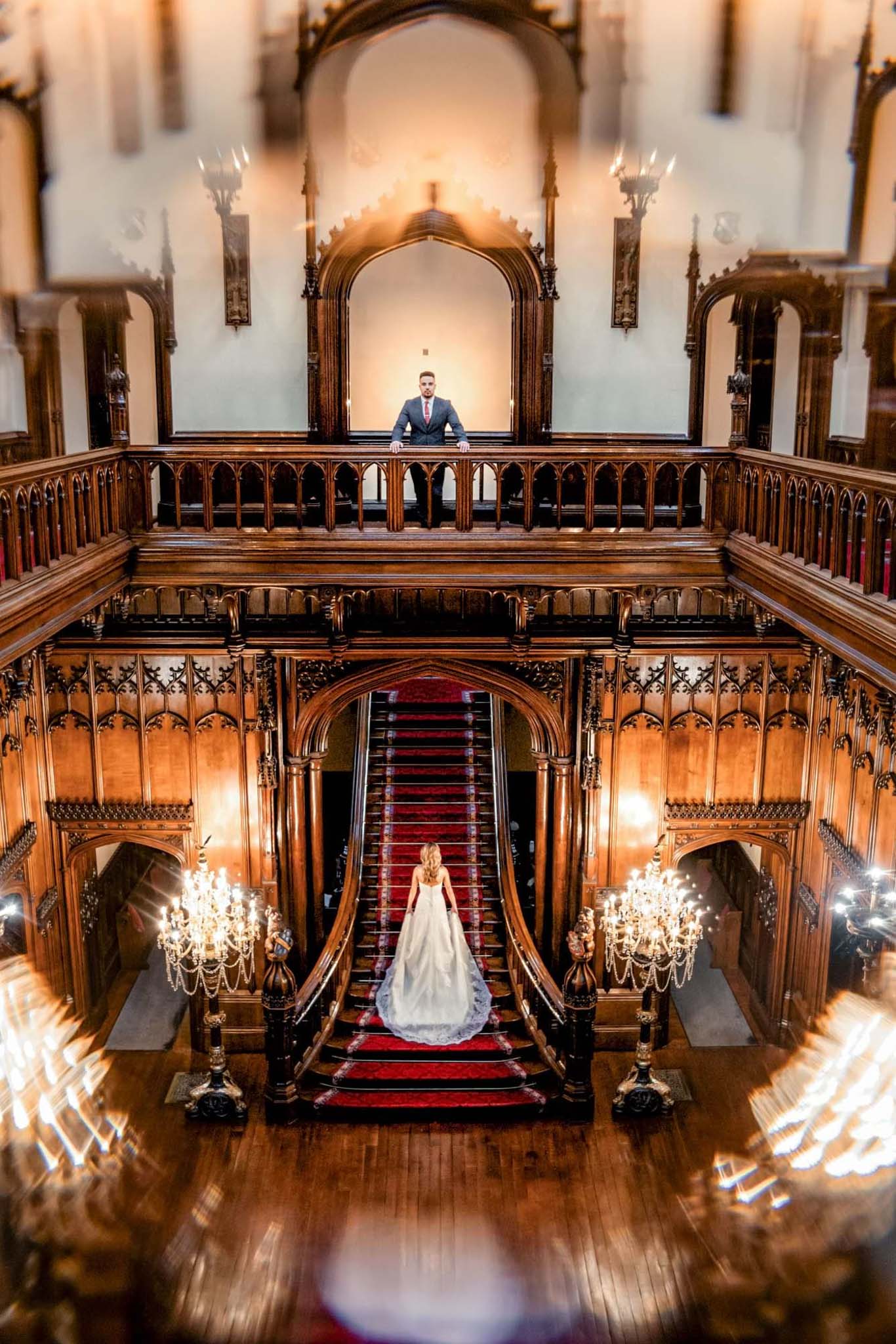 If you want to gain a average salary as a wedding photographer in the UK you need to know how to take pictures indoor. Groom at the top floor looking towards the camera, while the bride is walking the stairs towards him at the lower level.